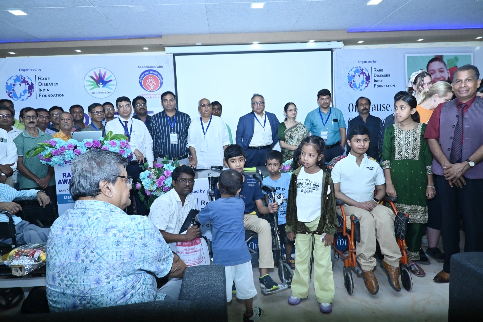 A speaker addressing the audience at the Rare Diseases Awareness 2025 conference.